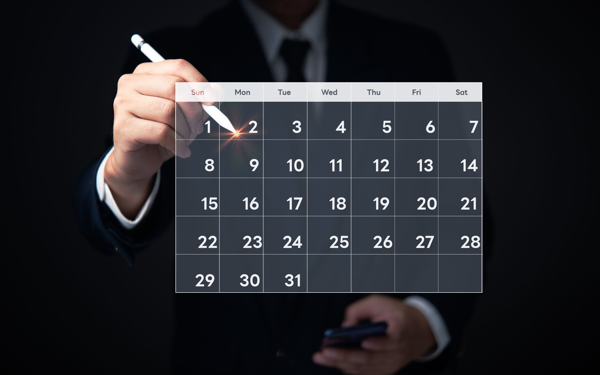 Businessman highlighting date on digital calendar, indicating business planning and scheduling.